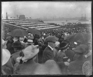 People crowd around to see children forming a living American flag.