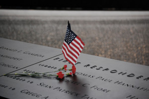 American flag and flowers at the National September 11 Memorial