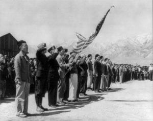 Members of the Manzanar American Legion and Boy Scouts honor the American flag on Memorial Day 1942. (Library of Congress)