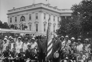 American flag flies on White House in 1929 while President Hoover stands next to one to welcome teens. (Library of Congress)