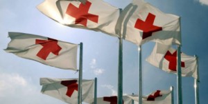 Red Cross flags fly.