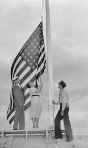 Rep. Nan Honeyman of Oregon lowers a flag at the Capitol in 1938. (Library of Congress)