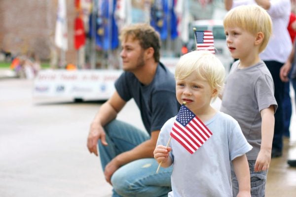 Children Holding American Flags at Parade