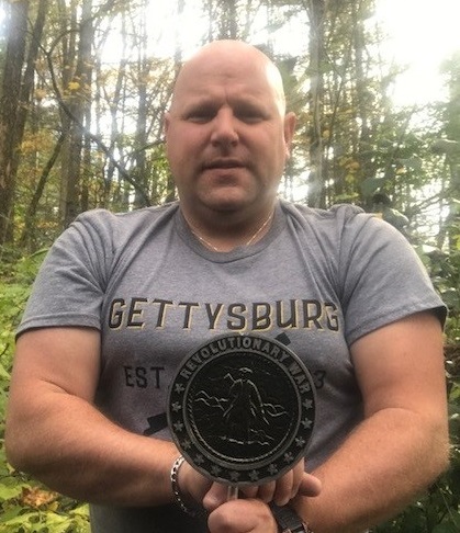 Matt Kelly holds Military Grave Marker