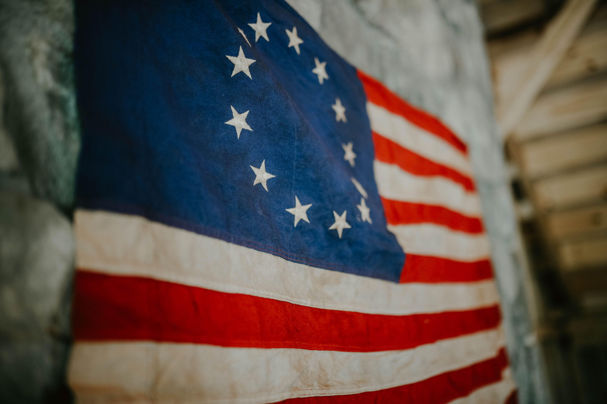 betsey ross flag on a stone wall