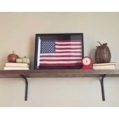 Framed American flag on shelf